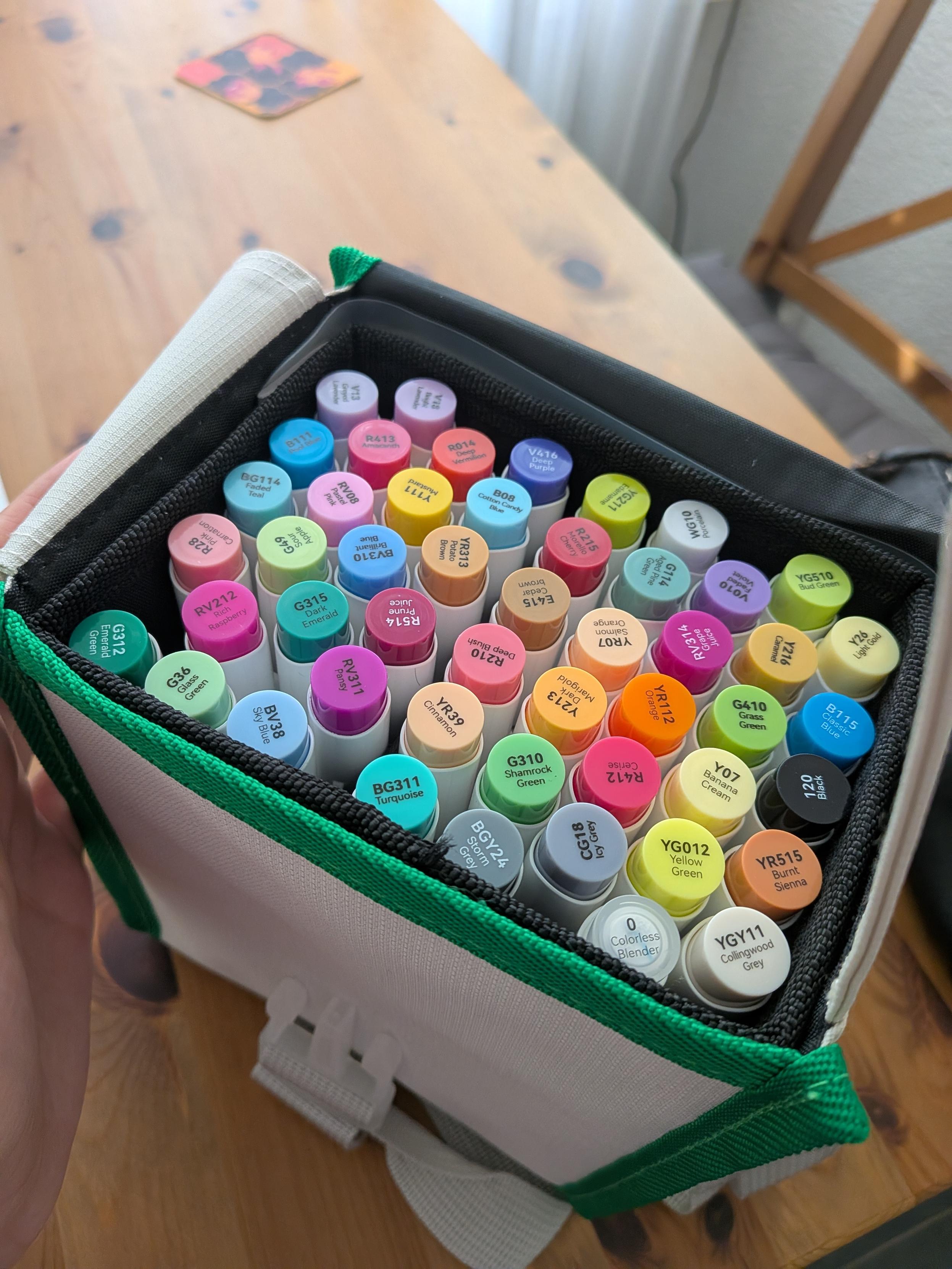 A container of markers randomly arranged in it.