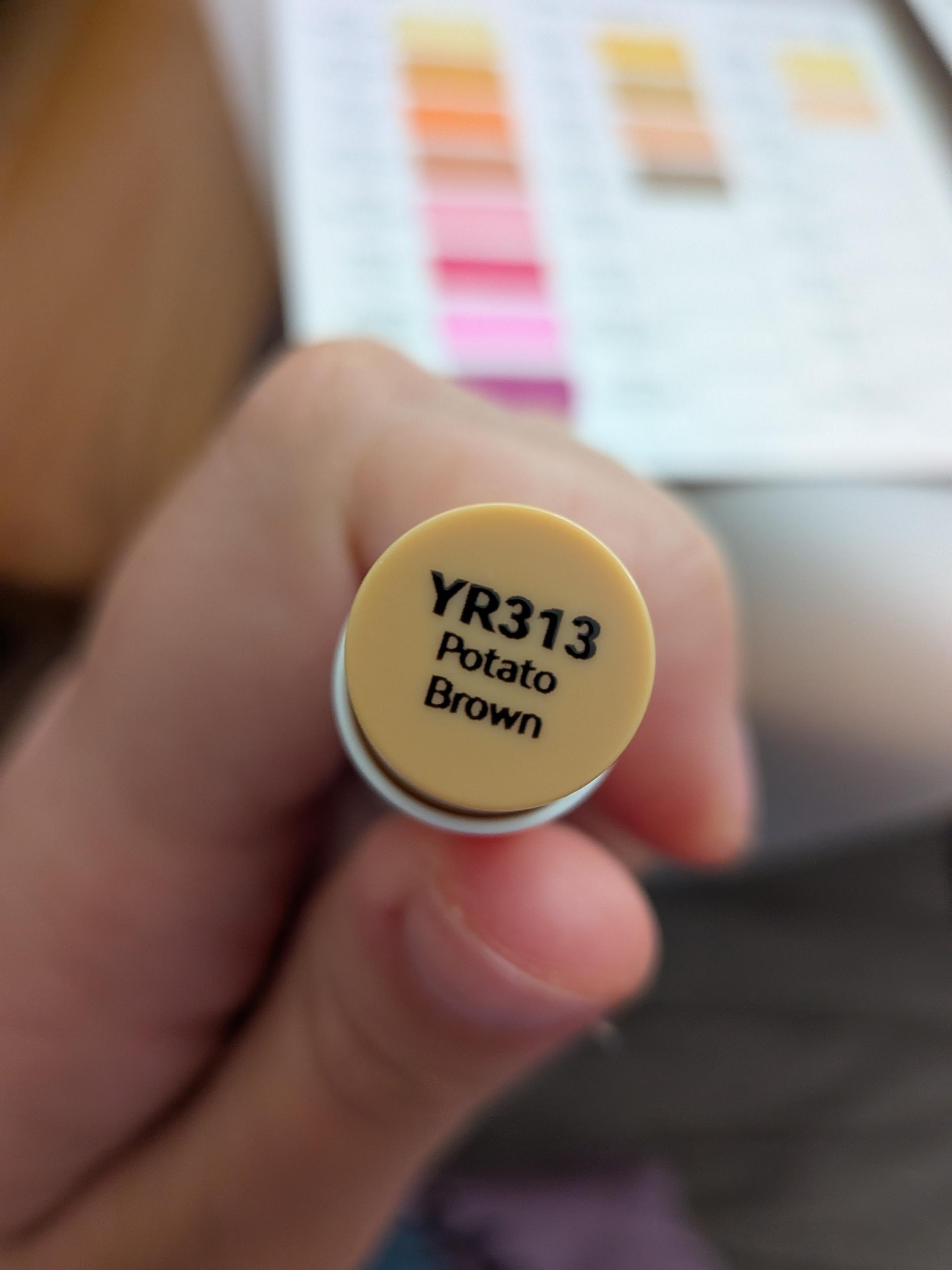 A marker cap with color name on it. It says "Potato brown"