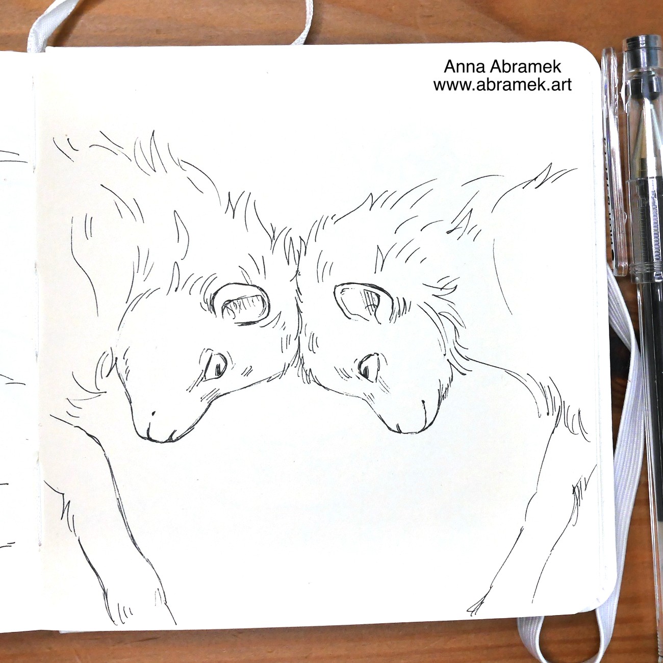 A pen drawing of two baby goats ramming their heads.
