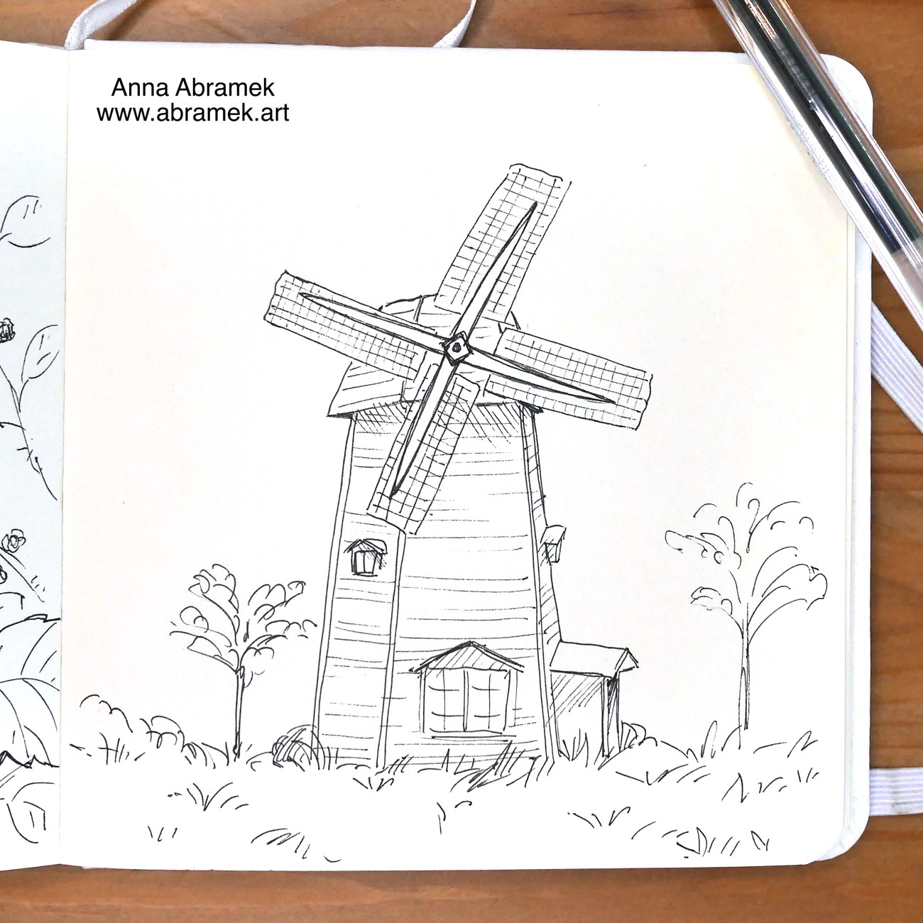 A pen drawing of a wooden windmill.